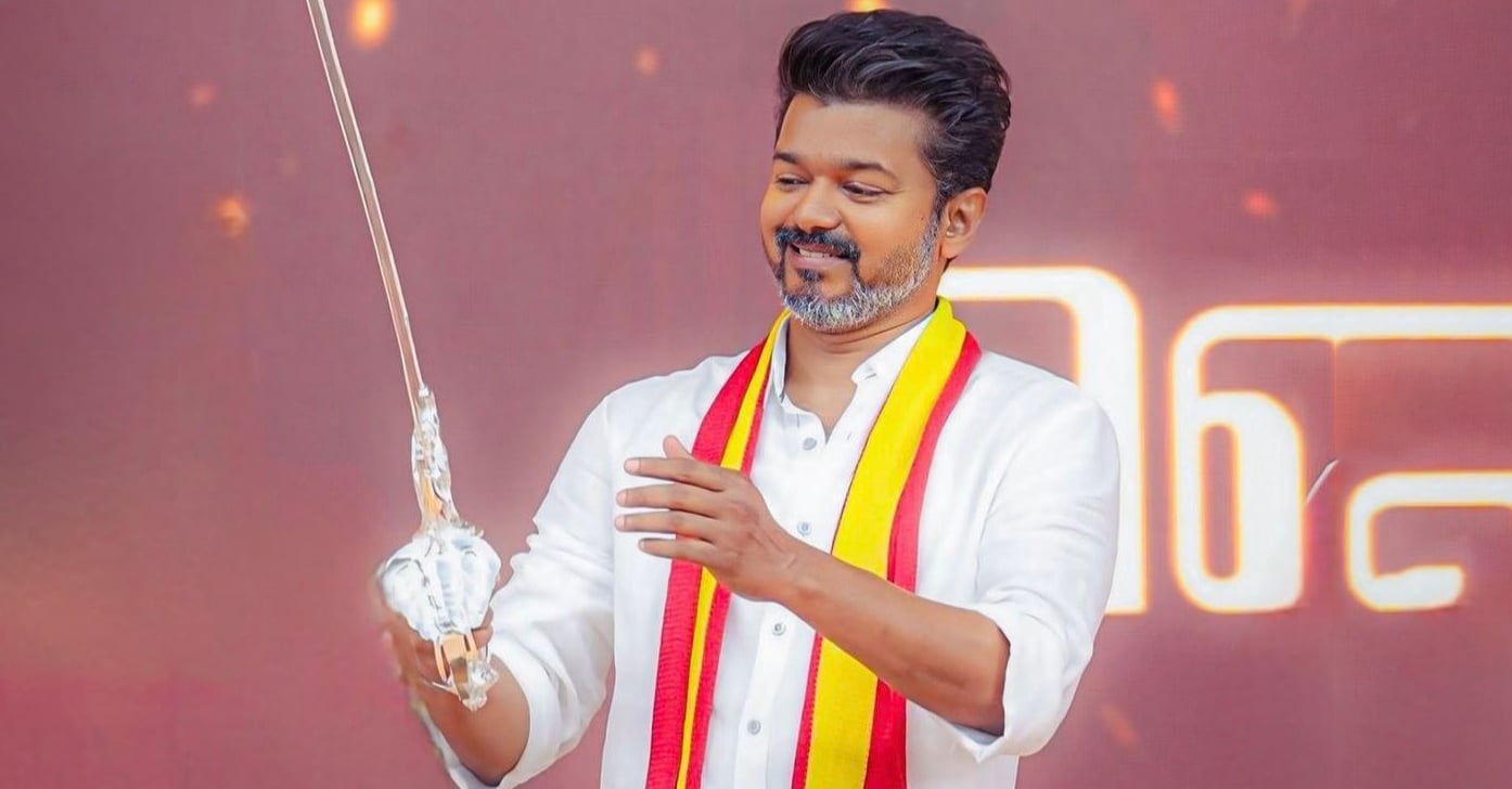 tvk leader vijay holding sword on stage